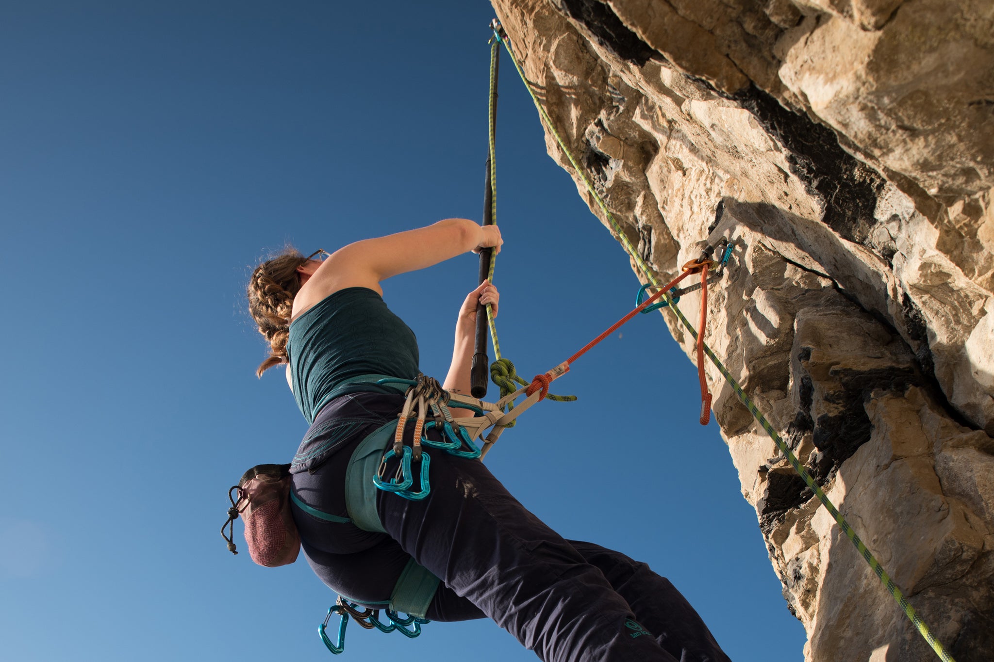 Pongoose blog - main image of climber using a Pongoose clipstick / stick clip up a route at Portland