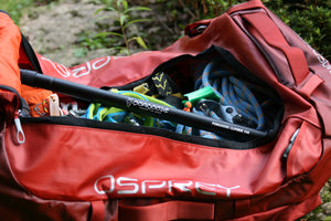 The Pongoose Climber 700 3in1 clipstick, brushing stick and camera boom featured with green head colour shown, packed inside red Osprey Transporter bag for ease of travel.