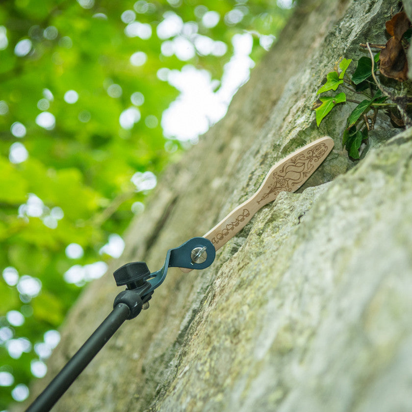 Pongoose Climber 700 brushing stick being used bouldering in Portland, UK, and pictured brushing an undercut hold.