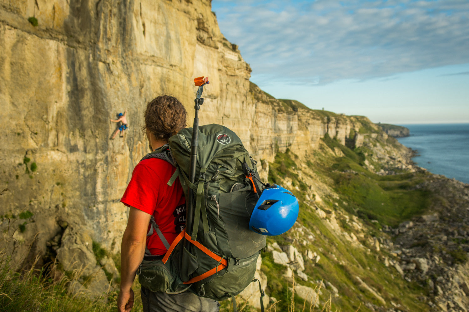 Pongoose Climber 700 featured attached to Osprey back pack at climbing area Blacknor, Portland, UK, with cliffs and blue sea in background.  